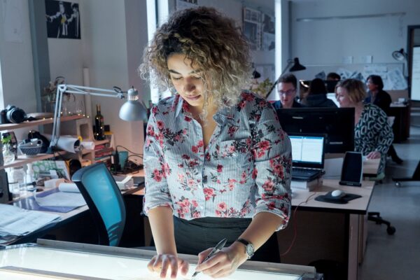 Architectural science student examines blueprints