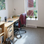 Tall Timber room with desk and bed